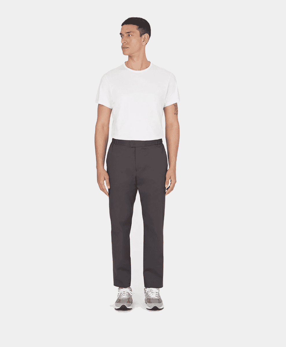 Model in dark gray tailored trousers with a white crew-neck t-shirt.