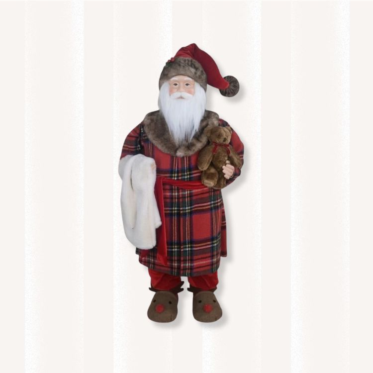 Santa Claus figurine dressed in red plaid pajamas.