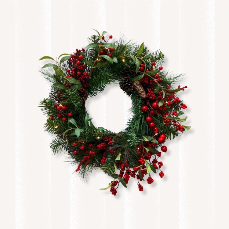 Holiday wreath with pinecones and red berries.