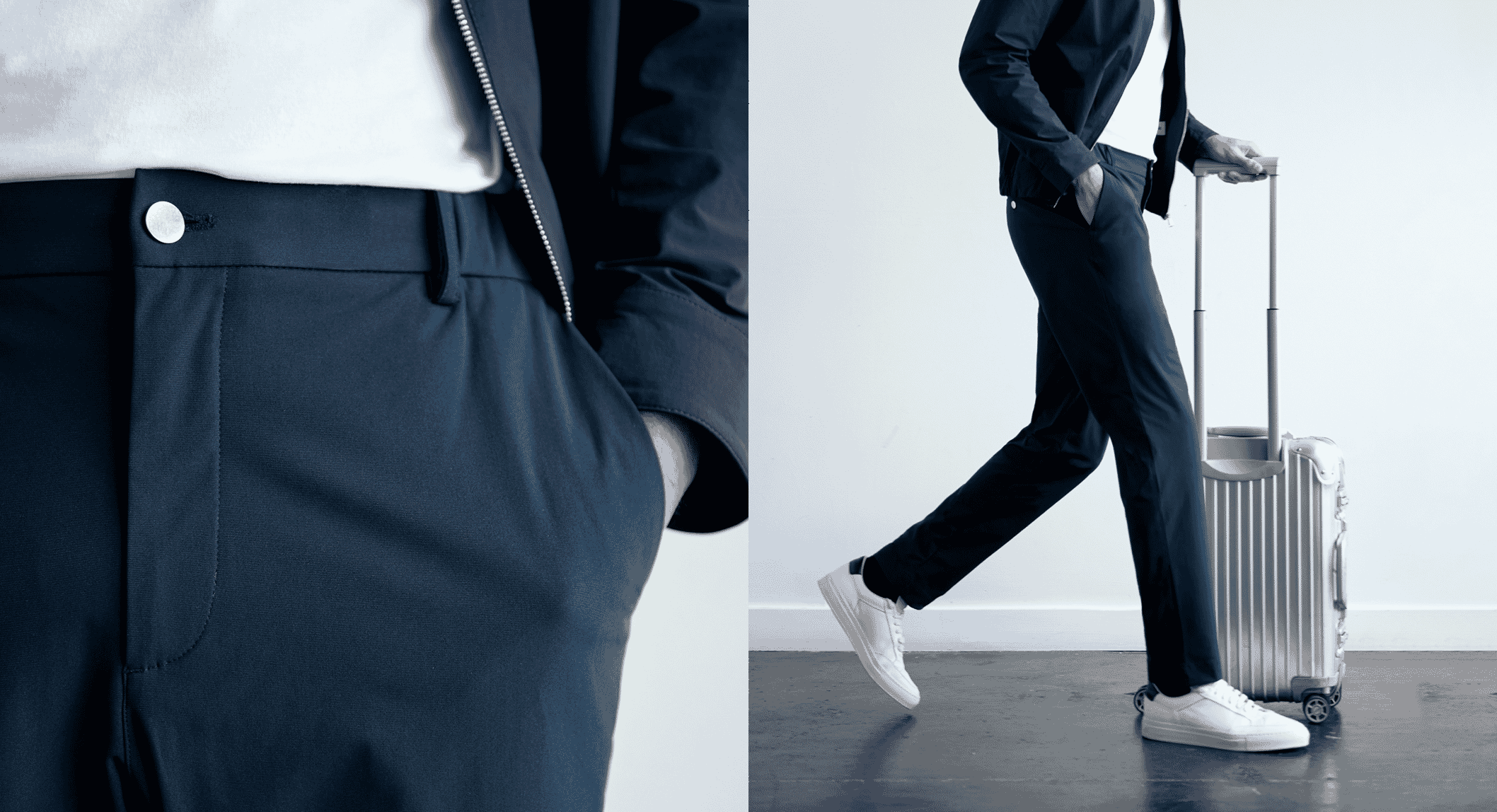 A man in a navy jacket and trousers walking with a suitcase, showcasing minimalist menswear.