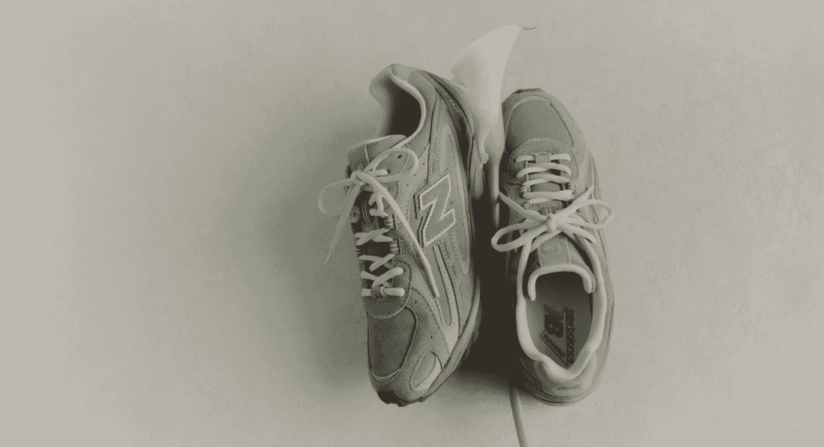Artistic monochrome photography of gray sneakers with a single flower petal.
