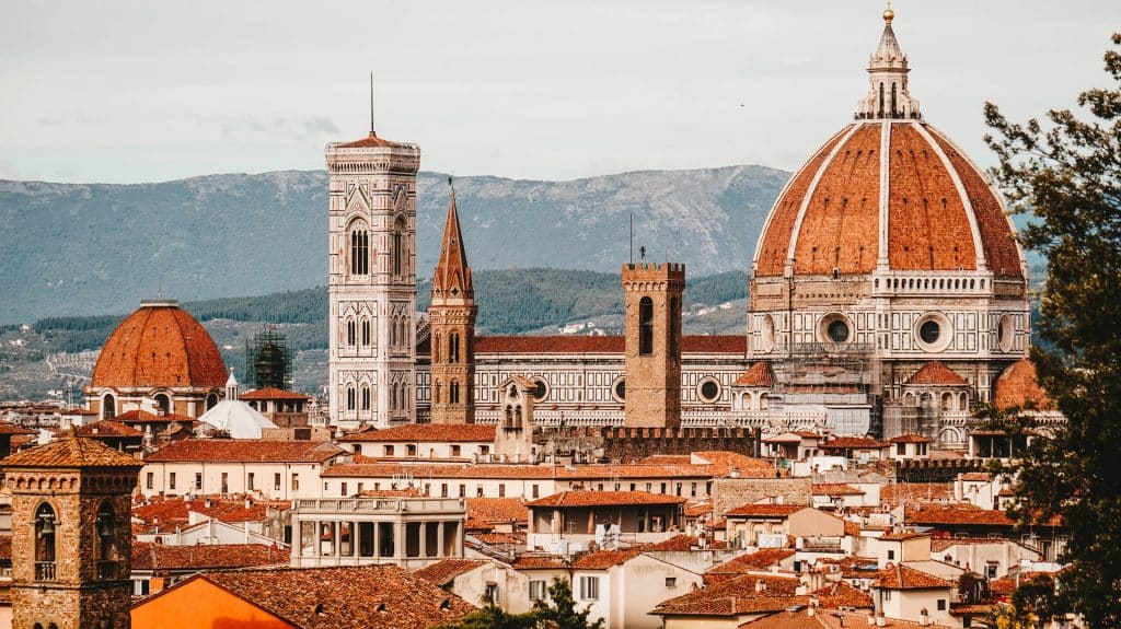Panoramic view of Florence’s historic skyline featuring the Duomo and Giotto’s Campanile against a backdrop of rolling hills.