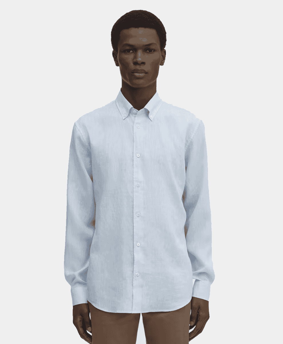 Minimalist studio shot of a white button-up linen shirt on a model.