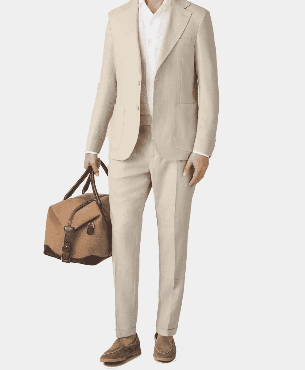 Man in a light beige linen suit holding a travel duffel bag.