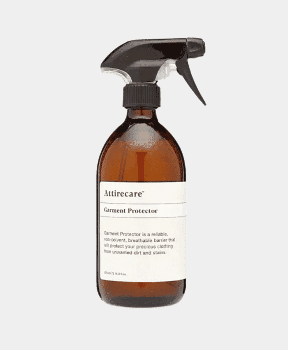 An amber bottle of Attirecare Garment Protector spray.