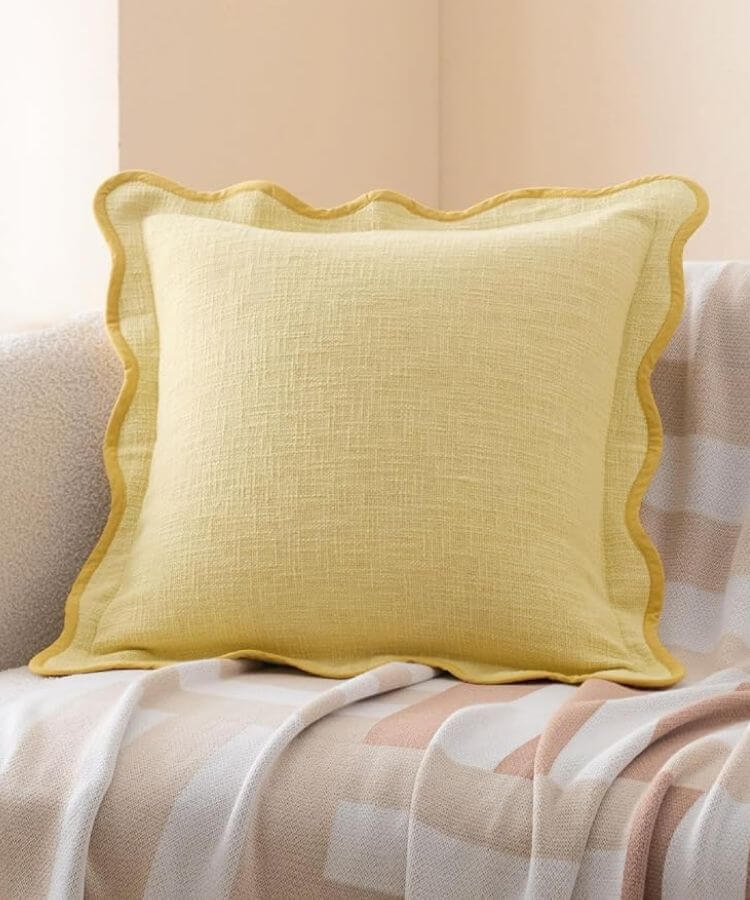Pillow covers with decorative scalloped edges in butter yellow.