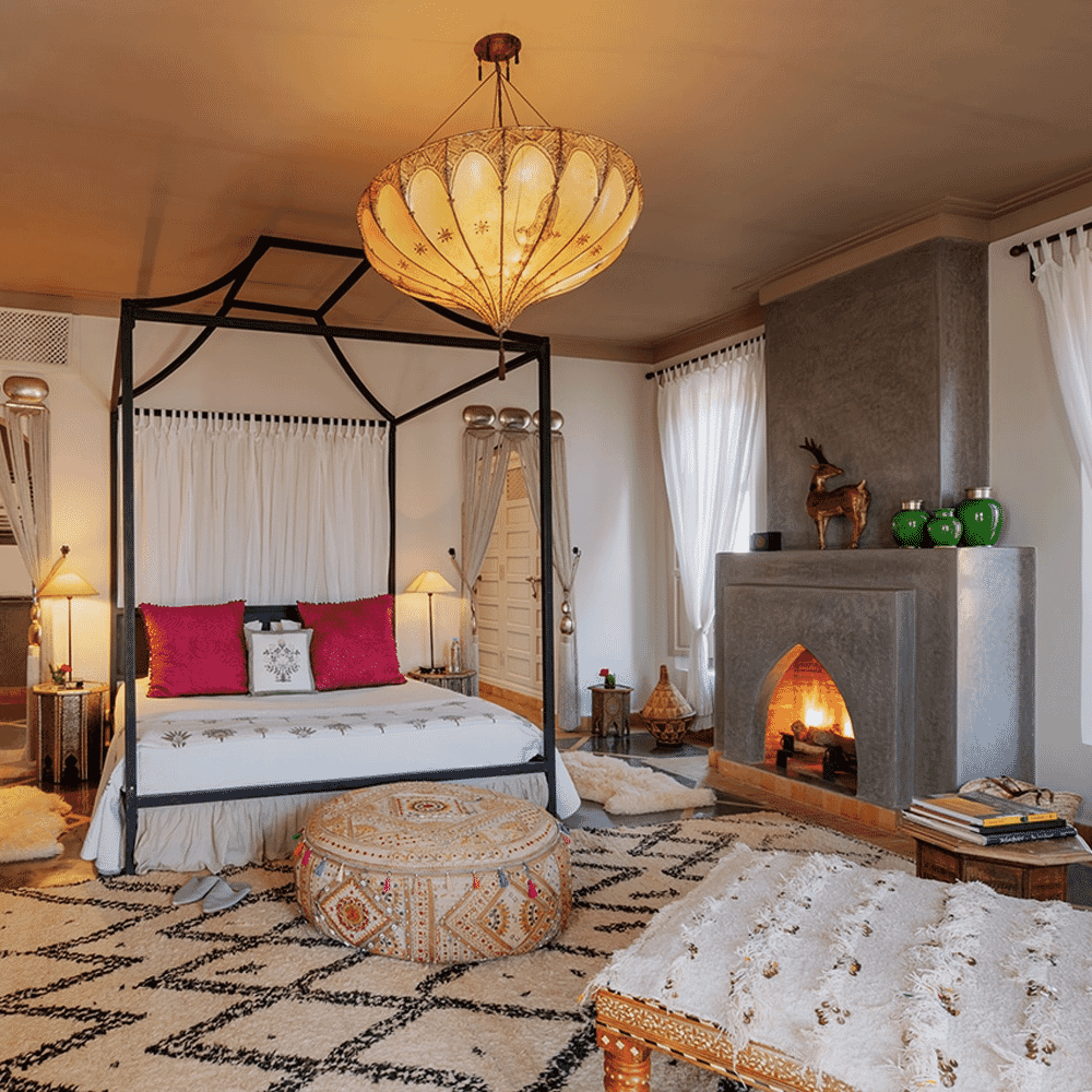 A cozy bedroom with a four-poster bed, intricate Moroccan rug, and warm ambient lighting.