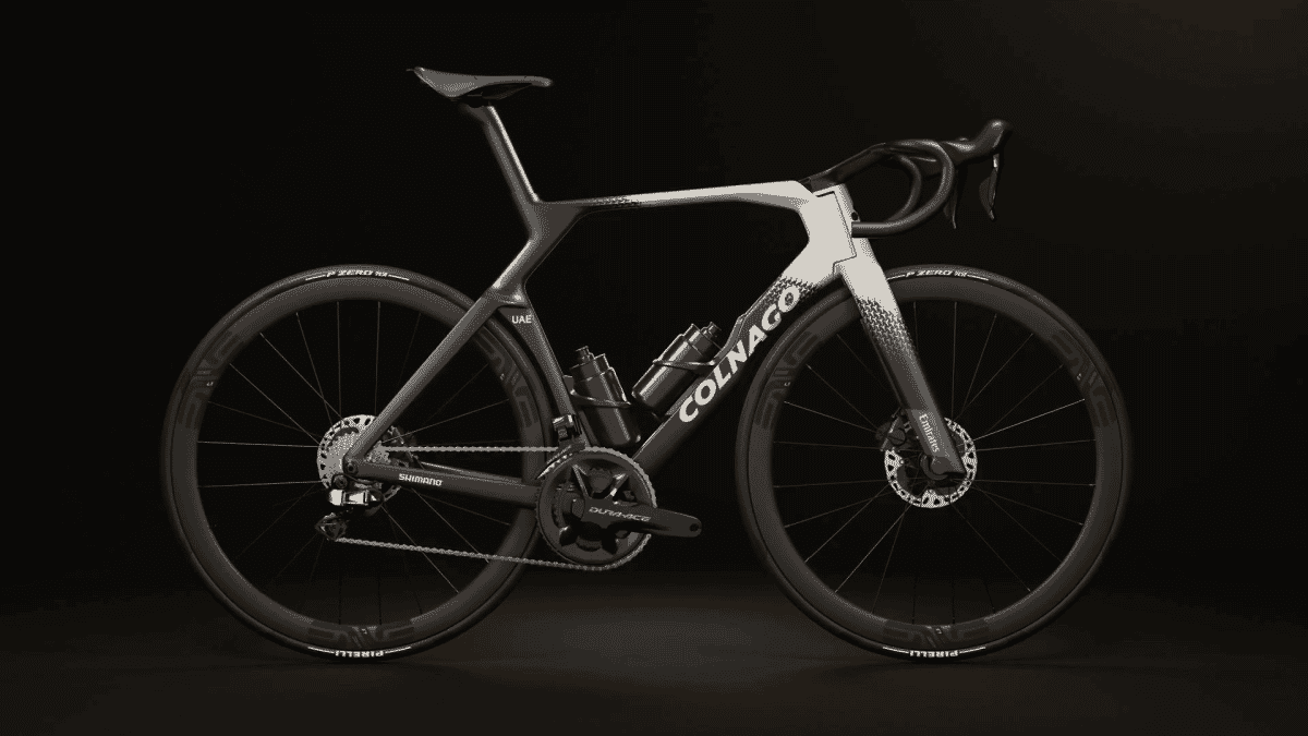 Monochrome image of a carbon Colnago road bike against a dark background.