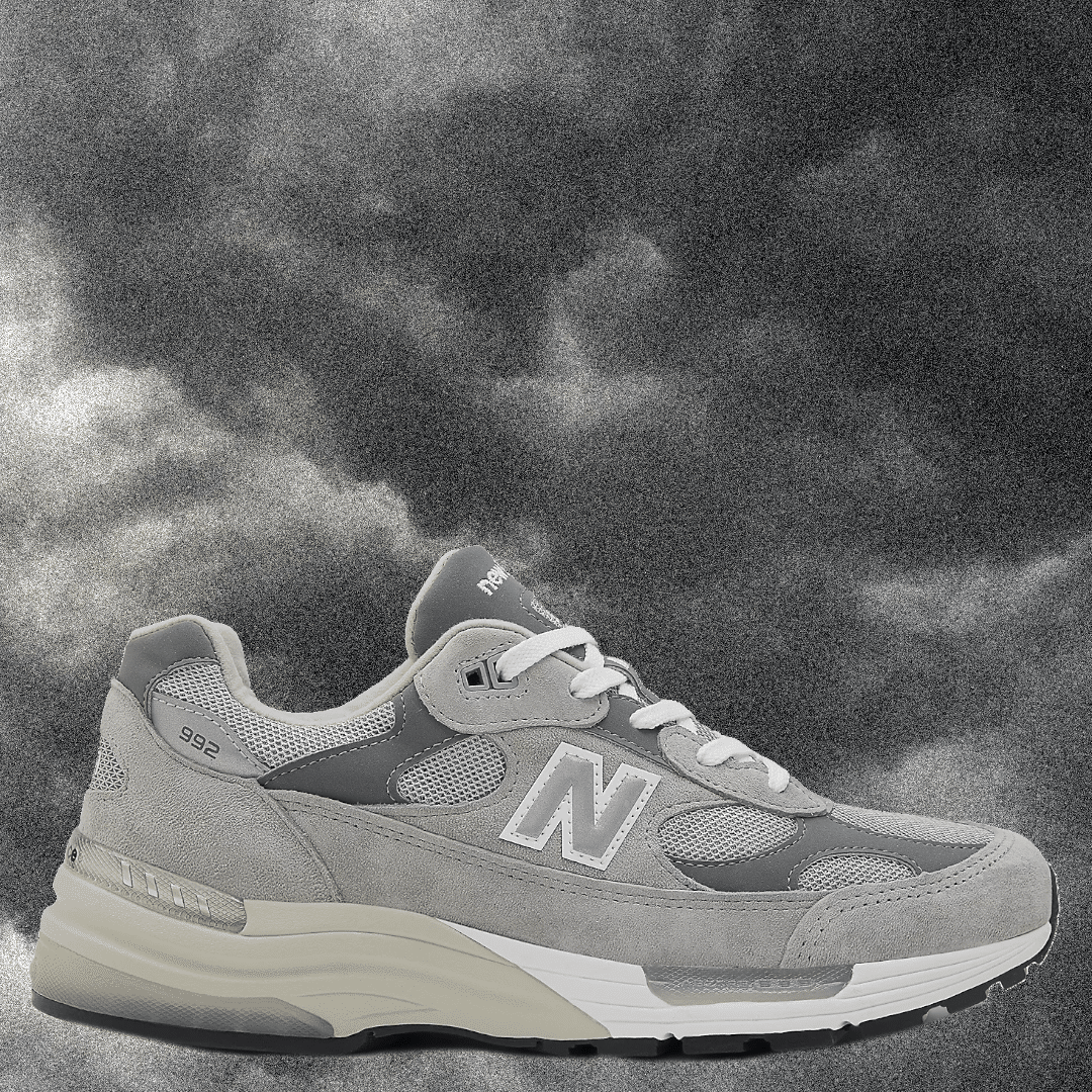 Gray New Balance 992 with white laces and mesh panels on a grayscale background.