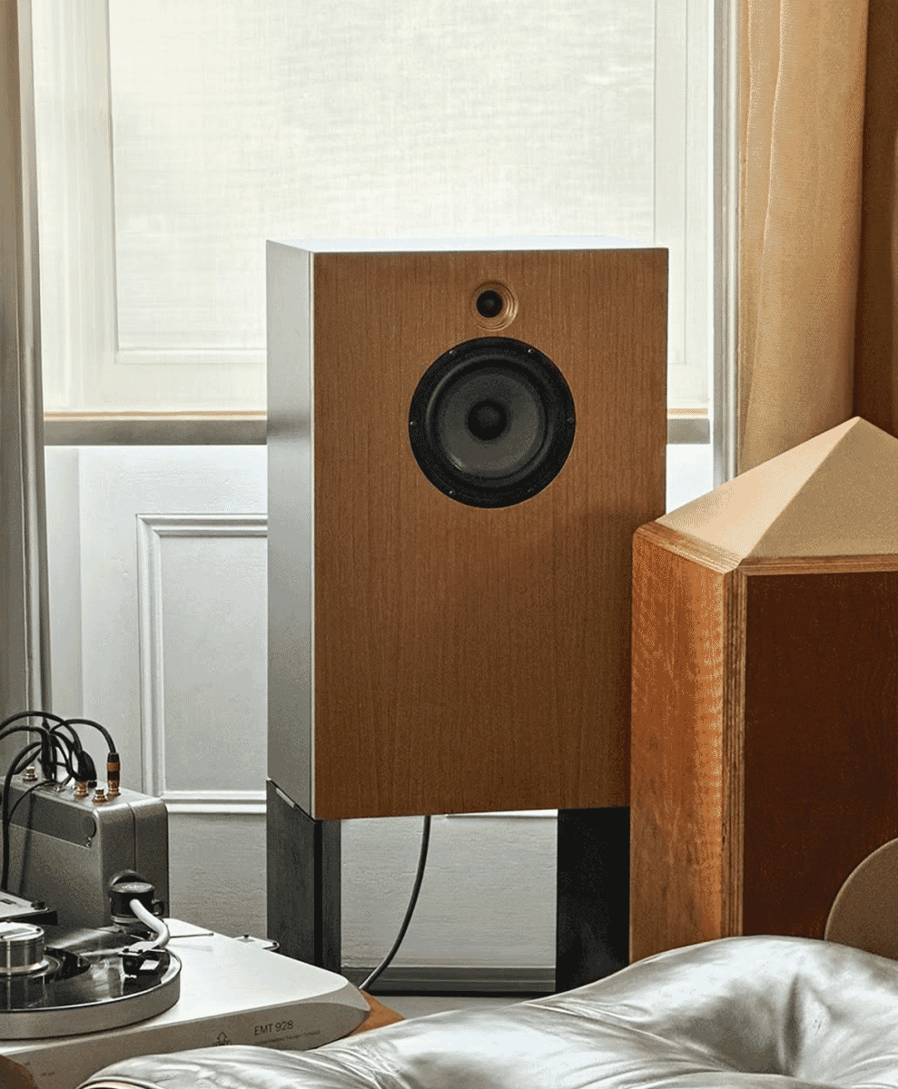 A cozy living room scene with a leather sofa, wooden speakers, and a turntable.