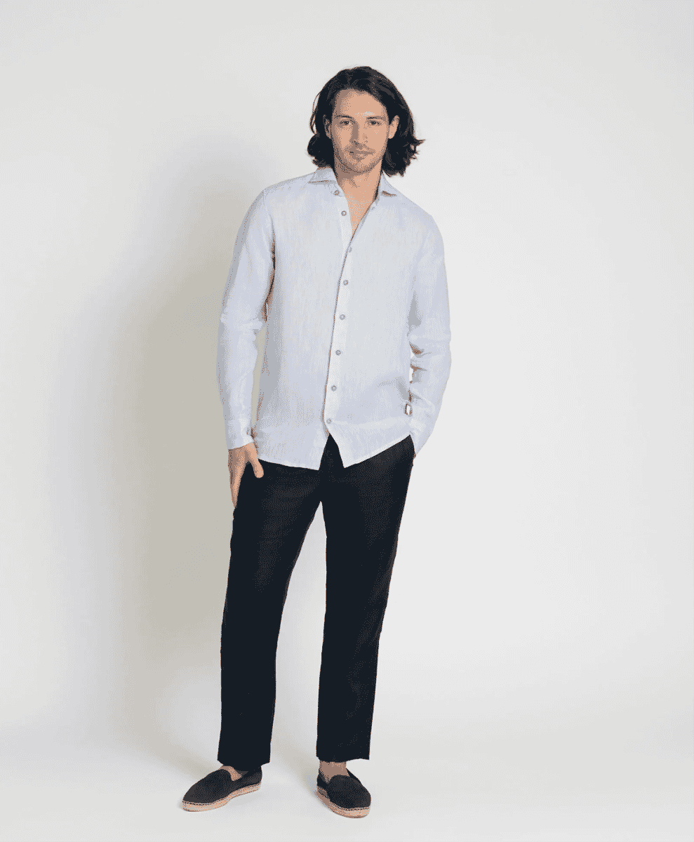Man wearing a light blue long-sleeve linen shirt and black trousers.