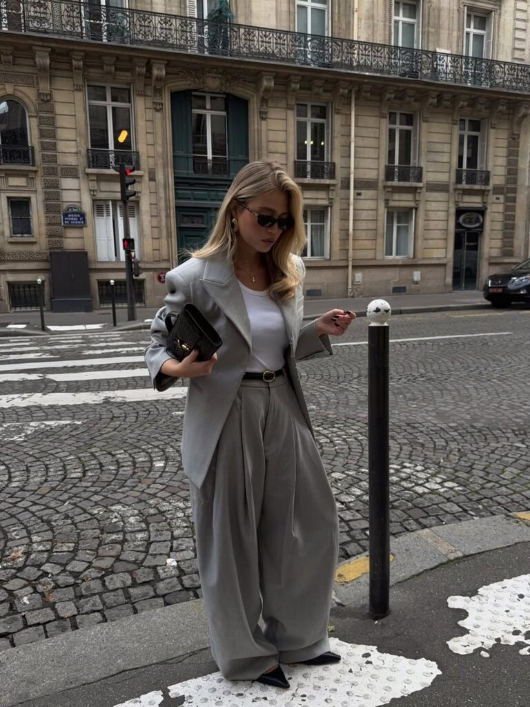 Woman wearing a sophisticated seasonal knit cardigan paired with a midi skirt.