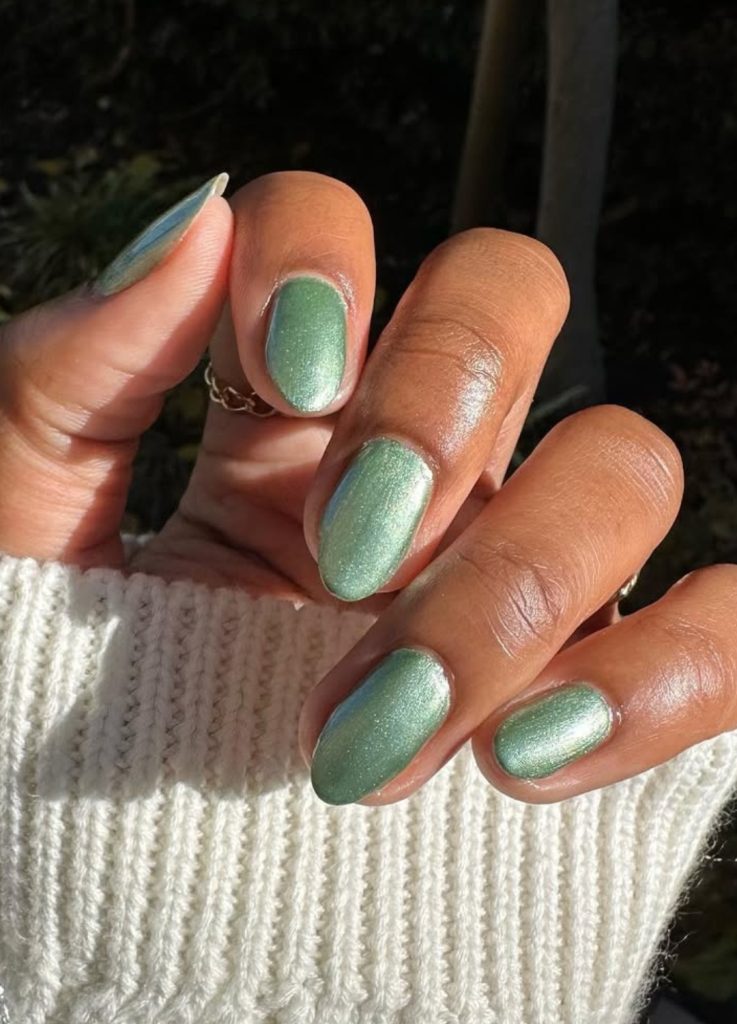 Metallic forest green nails with a deep, moody shimmer.
