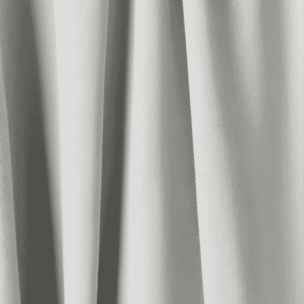 Close-up of draped white luxury fabric with soft folds and shadows.