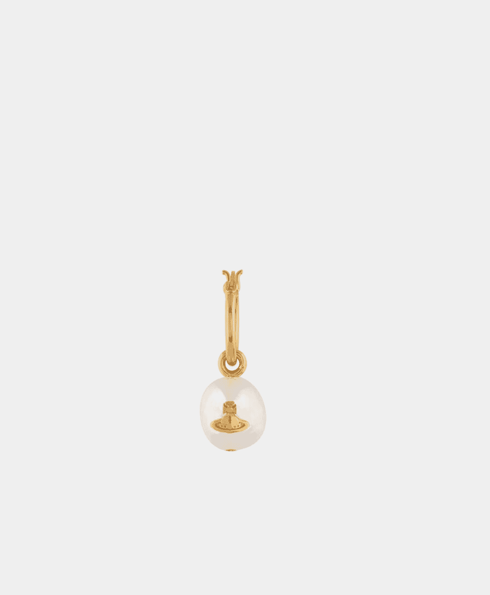 Close-up of a Vivienne Westwood gold-toned pearl charm with the orb logo.