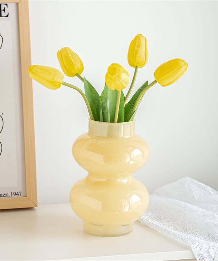 Milky yellow glass vase with a soft, semi-opaque finish.