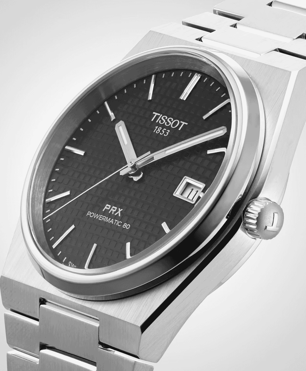 Close-up of a Tissot PRX Powermatic 80 with a black waffle-textured dial and silver bezel.