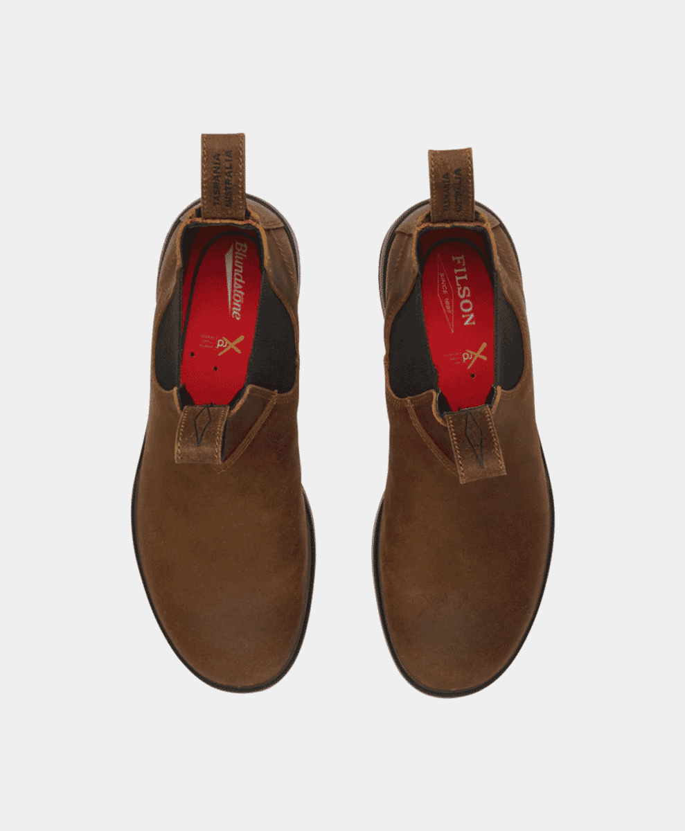 Top-down view of boots showing the red insoles with Blundstone and Filson logos.