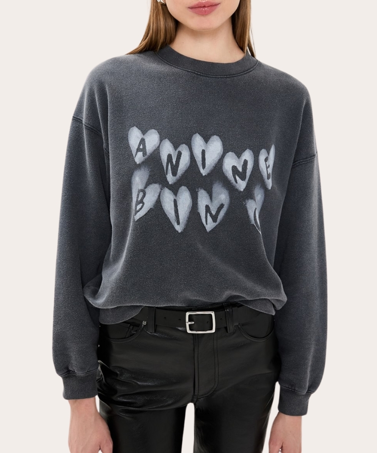 Cream sweatshirt with subtle red heart prints across the fabric.