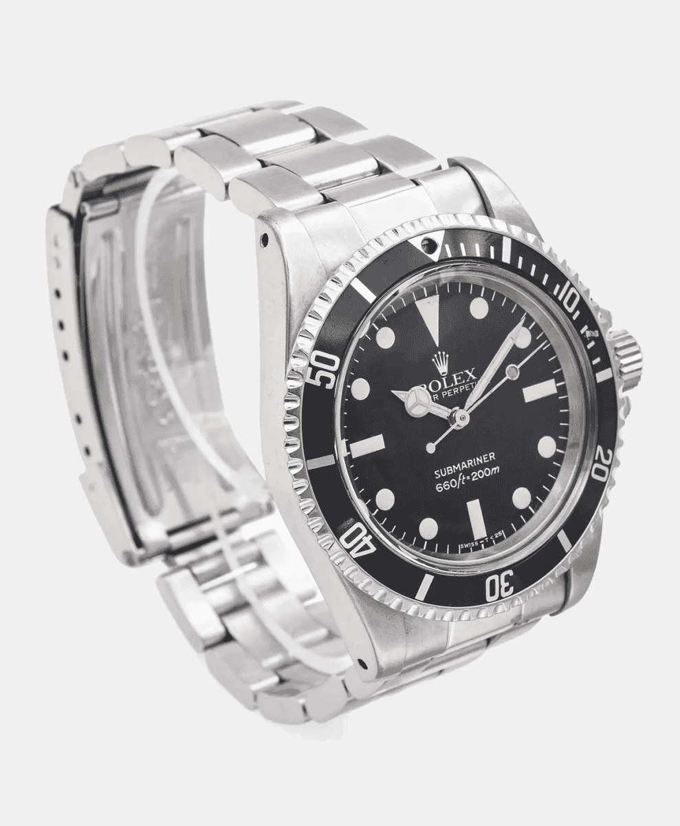 Technical close-up of a stainless steel Rolex Submariner 5513 against a neutral background.