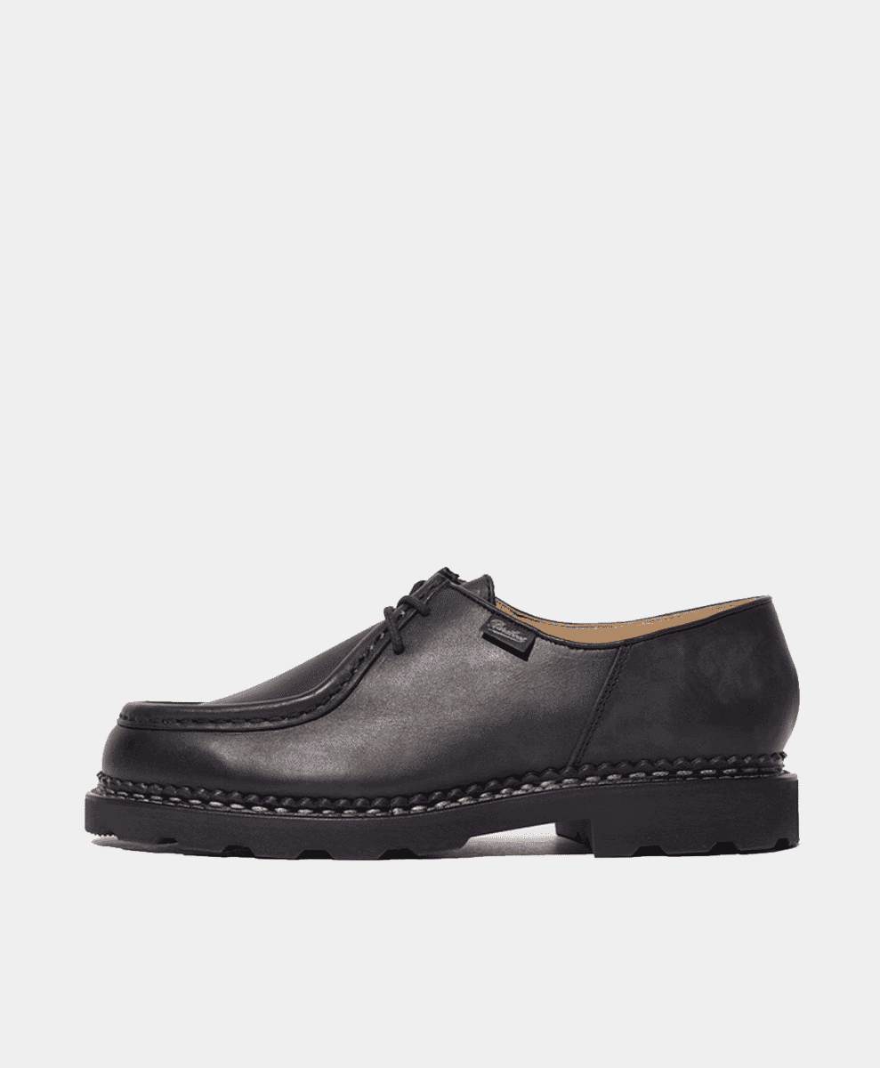 Profile shot of a black Paraboot Michael lace-up shoe with a thick rubber sole.