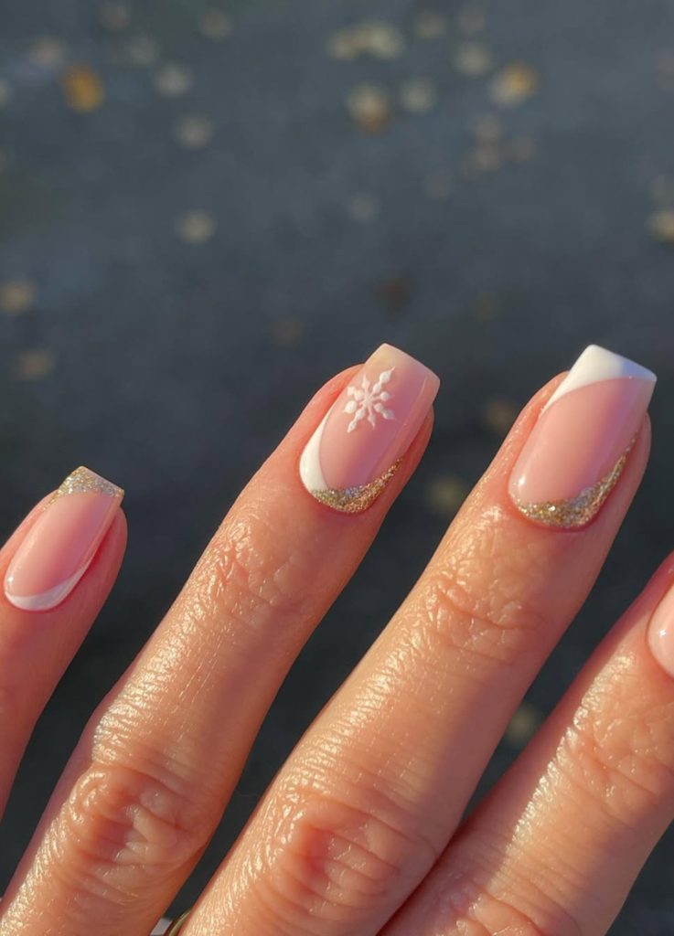 Minimalist white snowflake art on a sheer nude nail.