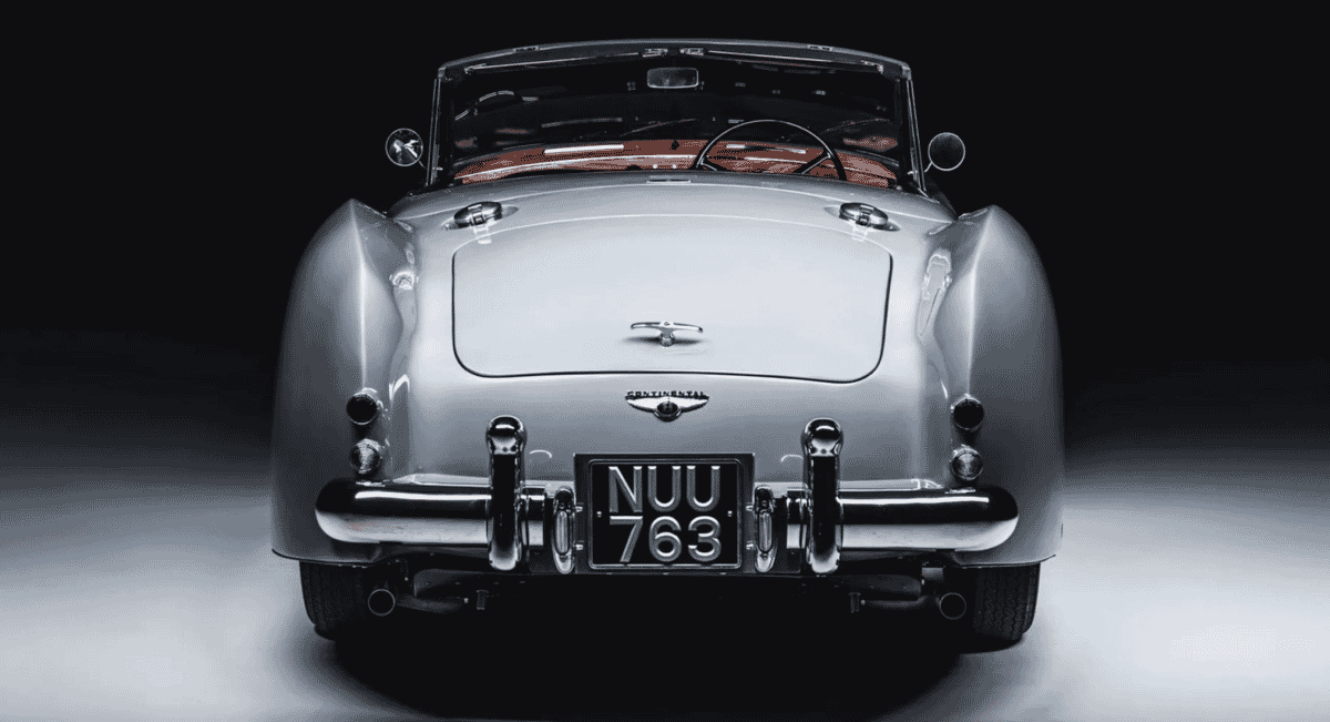Rear view of a classic silver Aston Martin DB2/4 convertible.
