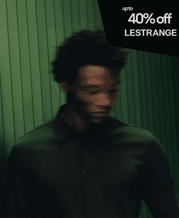 A man in a dark button-up shirt against a green paneled background with LESTRANGE sale text.