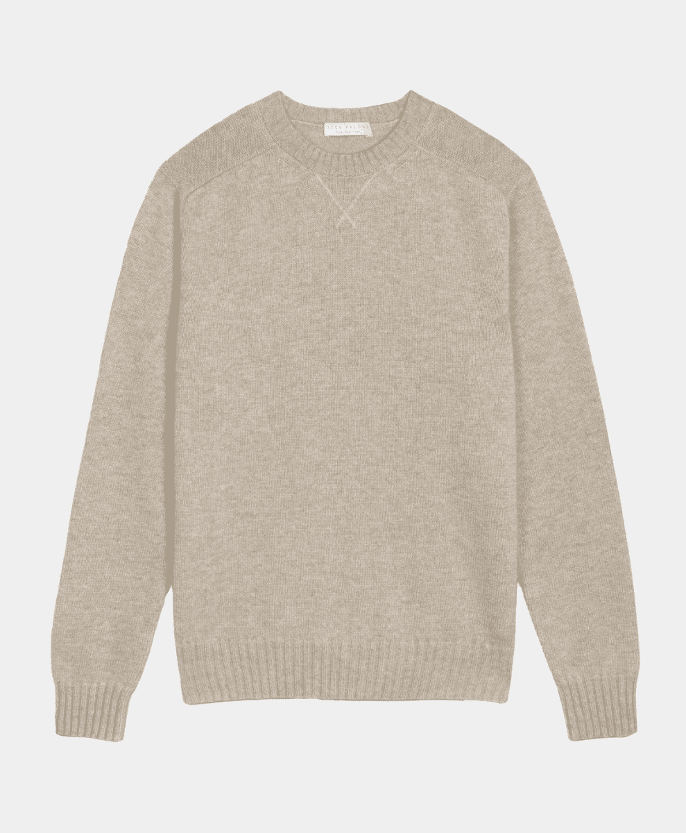 A beige crewneck sweater displayed flat against a neutral background showing its soft knit texture.