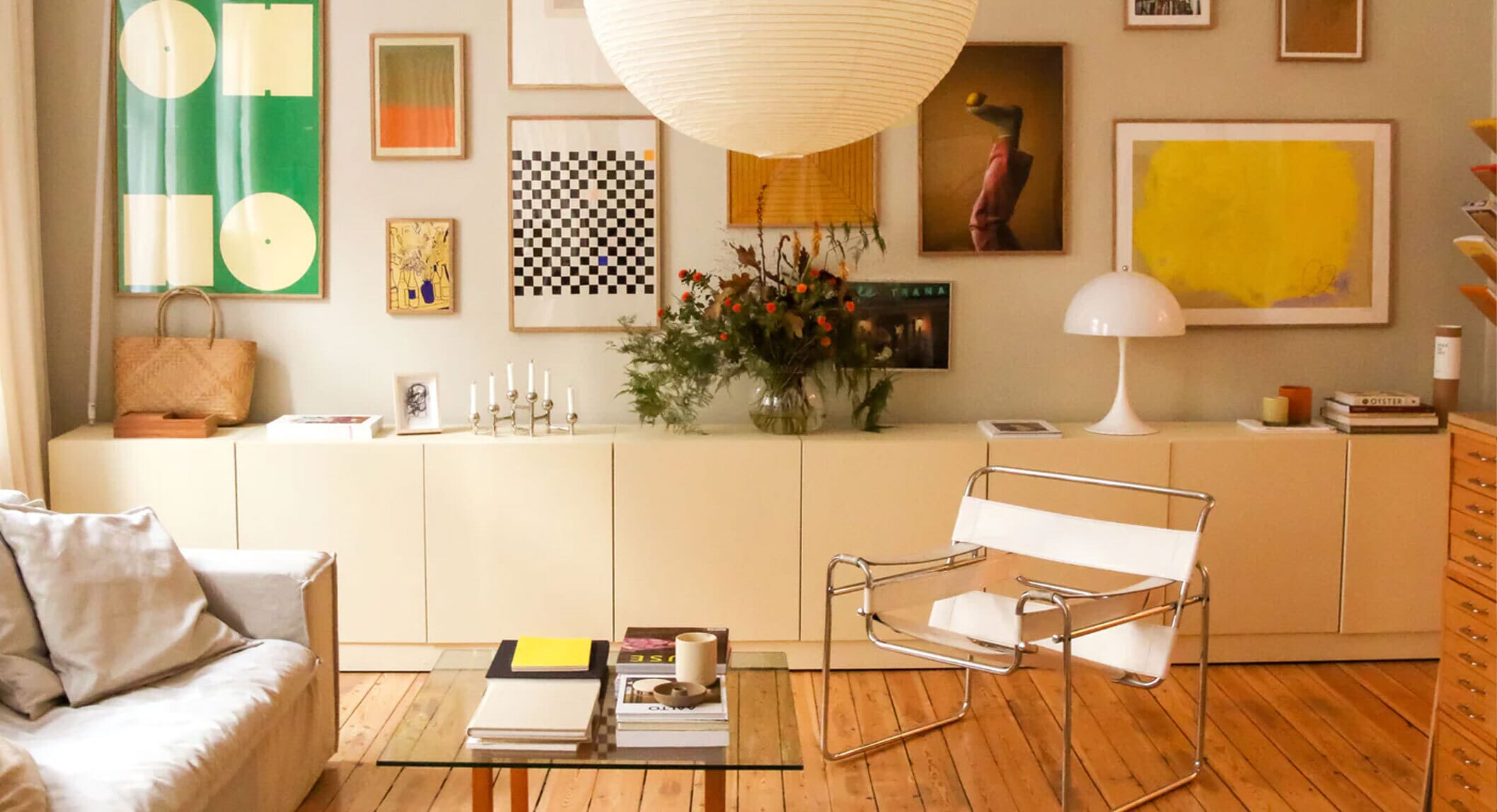 Cozy living room with minimalist furniture and art prints representing the new era of interior design.