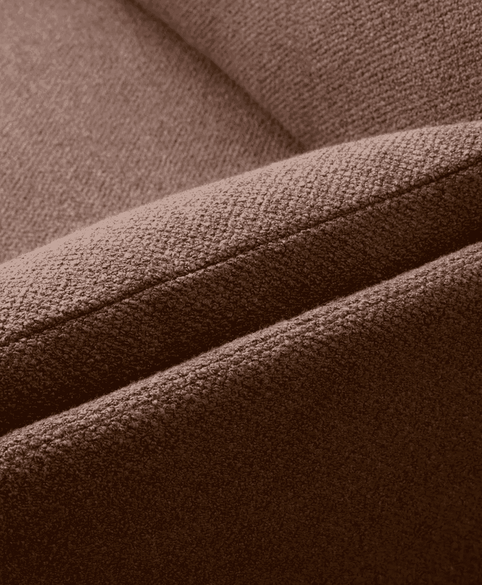 Close-up detail of textured brown bouclé upholstery fabric.