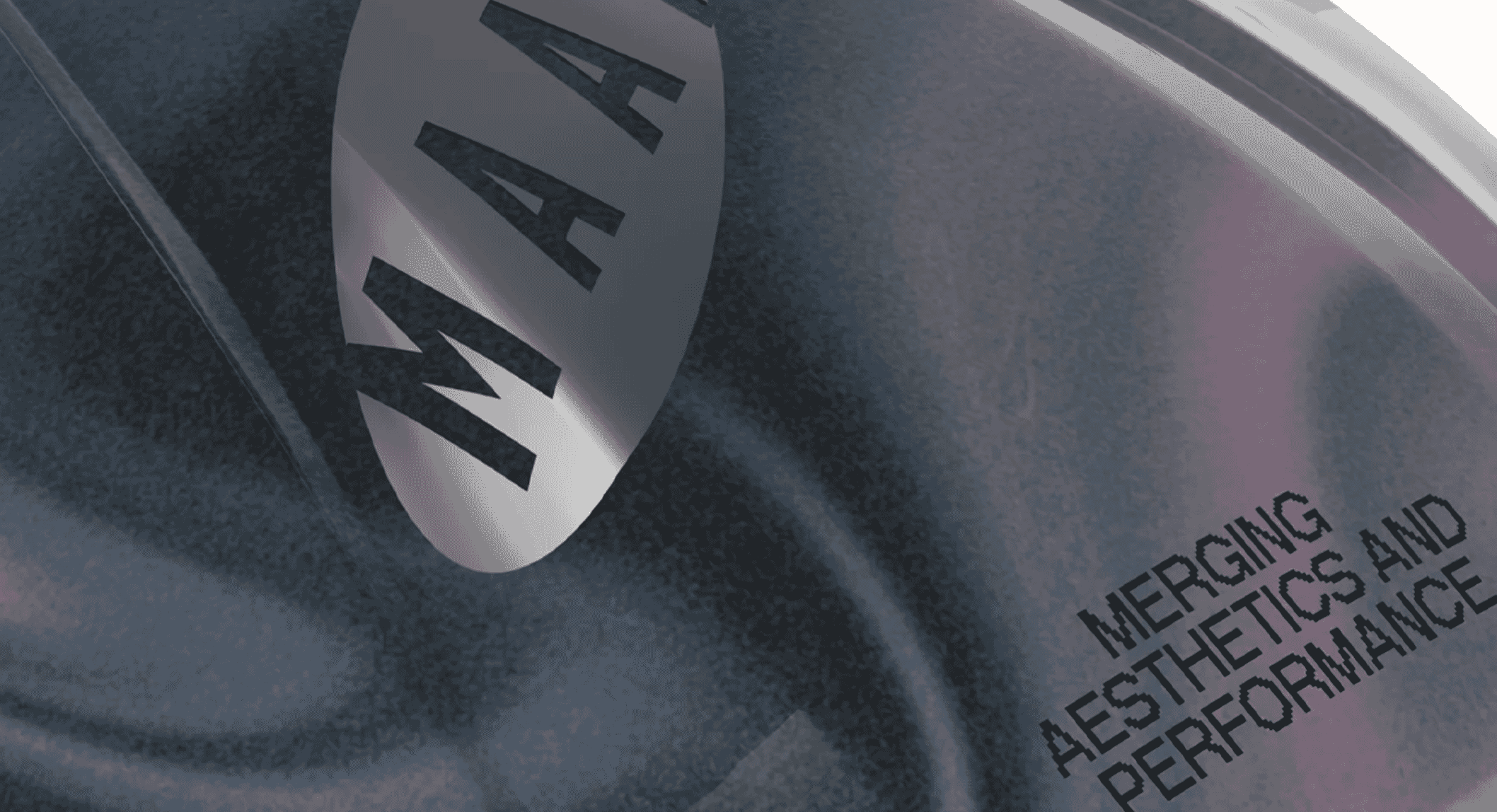 Close-up of a metallic MAAP logo and branding text on a textured performance garment.