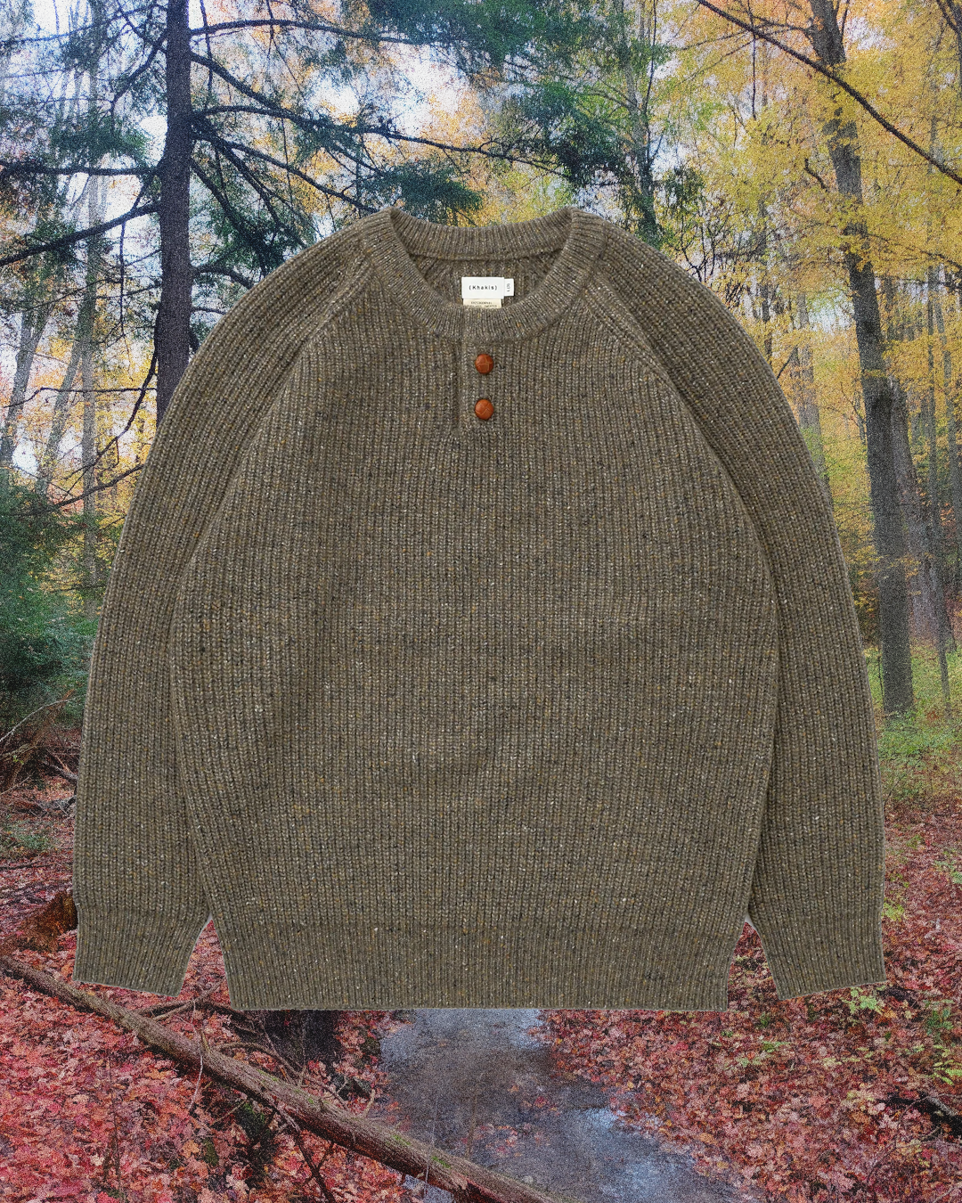 Olive-green ribbed knit sweater with wooden buttons and raglan sleeves.