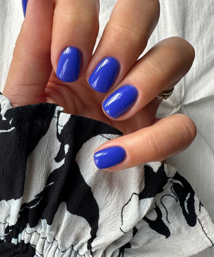 Striking cobalt blue manicure on almond nails.