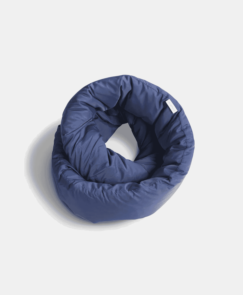 A navy blue padded neck pillow with a quilted texture displayed on a white background.