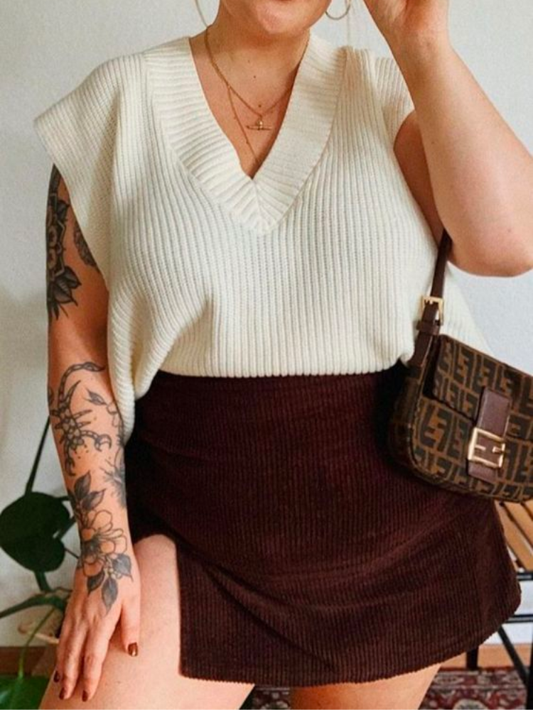 Pinterest aesthetic photo of a knit sweater vest and mini skirt.