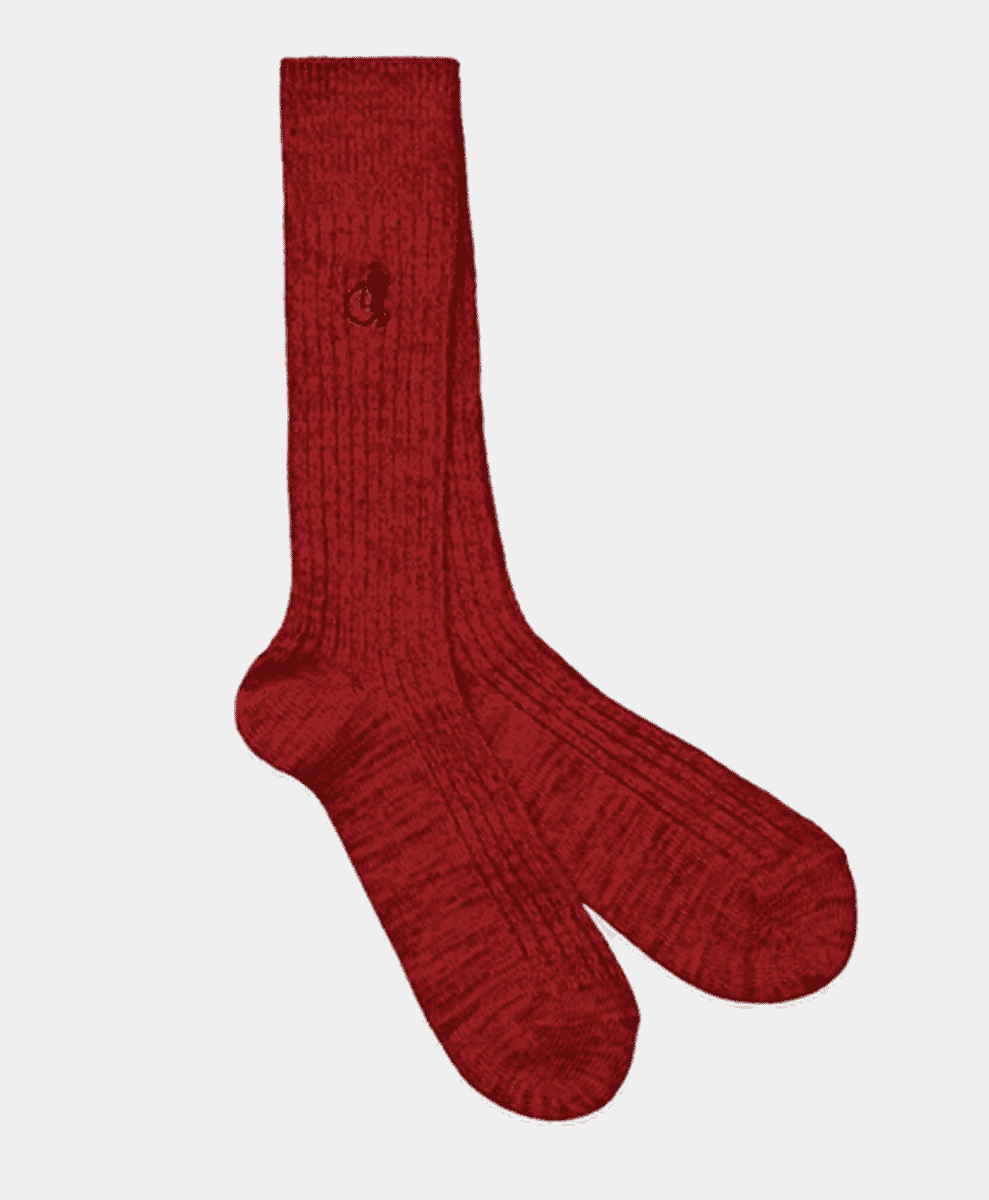 Deep red ribbed-knit boot socks against a plain background.