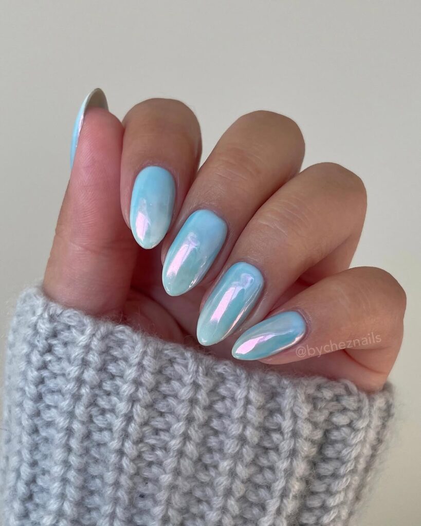 Side-view of metallic iridescent chrome nails demonstrating light reflection.