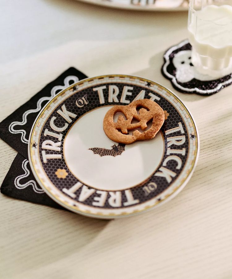 Stoneware dessert plate with 'Trick or Treat' written in a black and white bistro tile pattern.