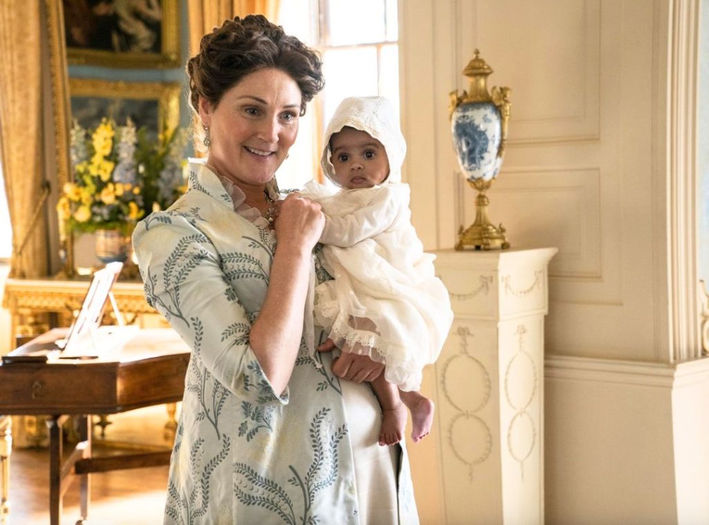 Daphne Bridgerton in a light blue Regency gown looking graceful