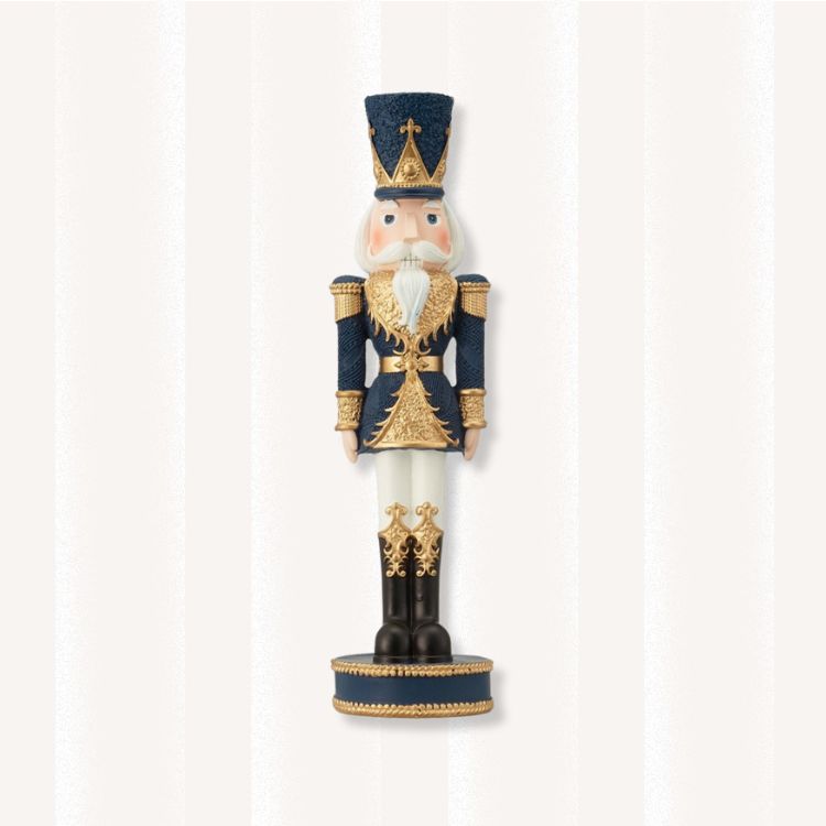 Nutcracker figurine wearing a navy and gold uniform.