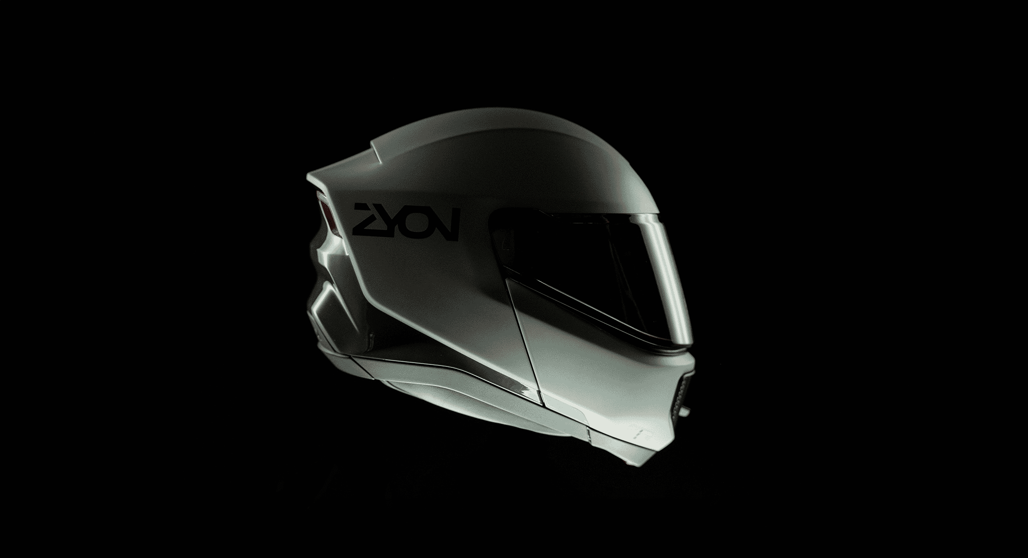 A white ZYON motorcycle helmet showcasing aerodynamic lines and futuristic branding.