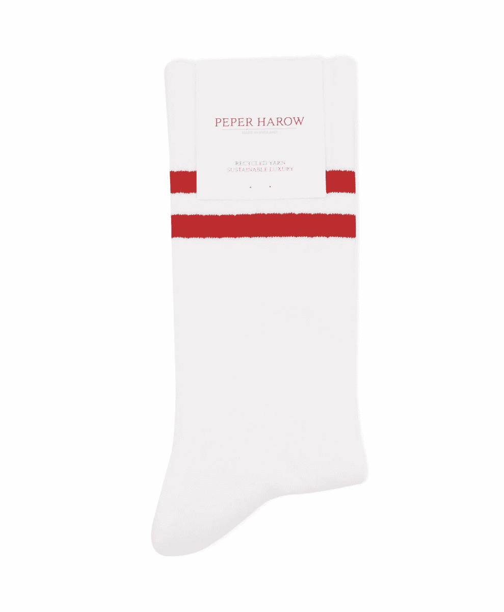 White athletic crew socks with red stripes and a 'Peper Harow' recycled yarn label.