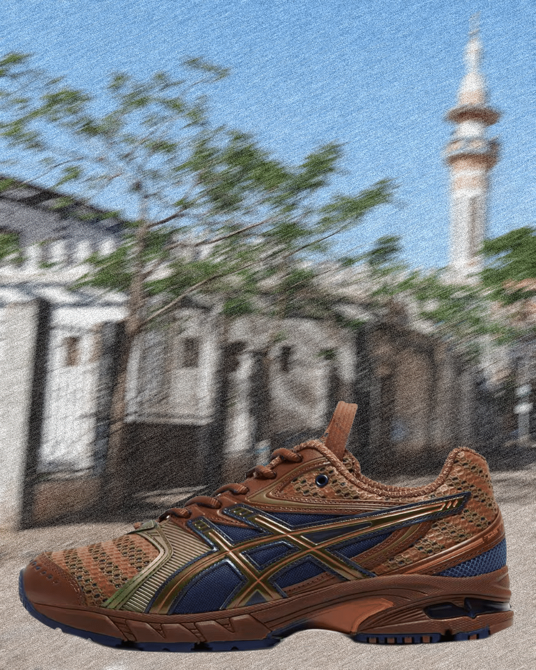 Brown and blue Asics sneaker featuring metallic details and textured mesh against a city backdrop.