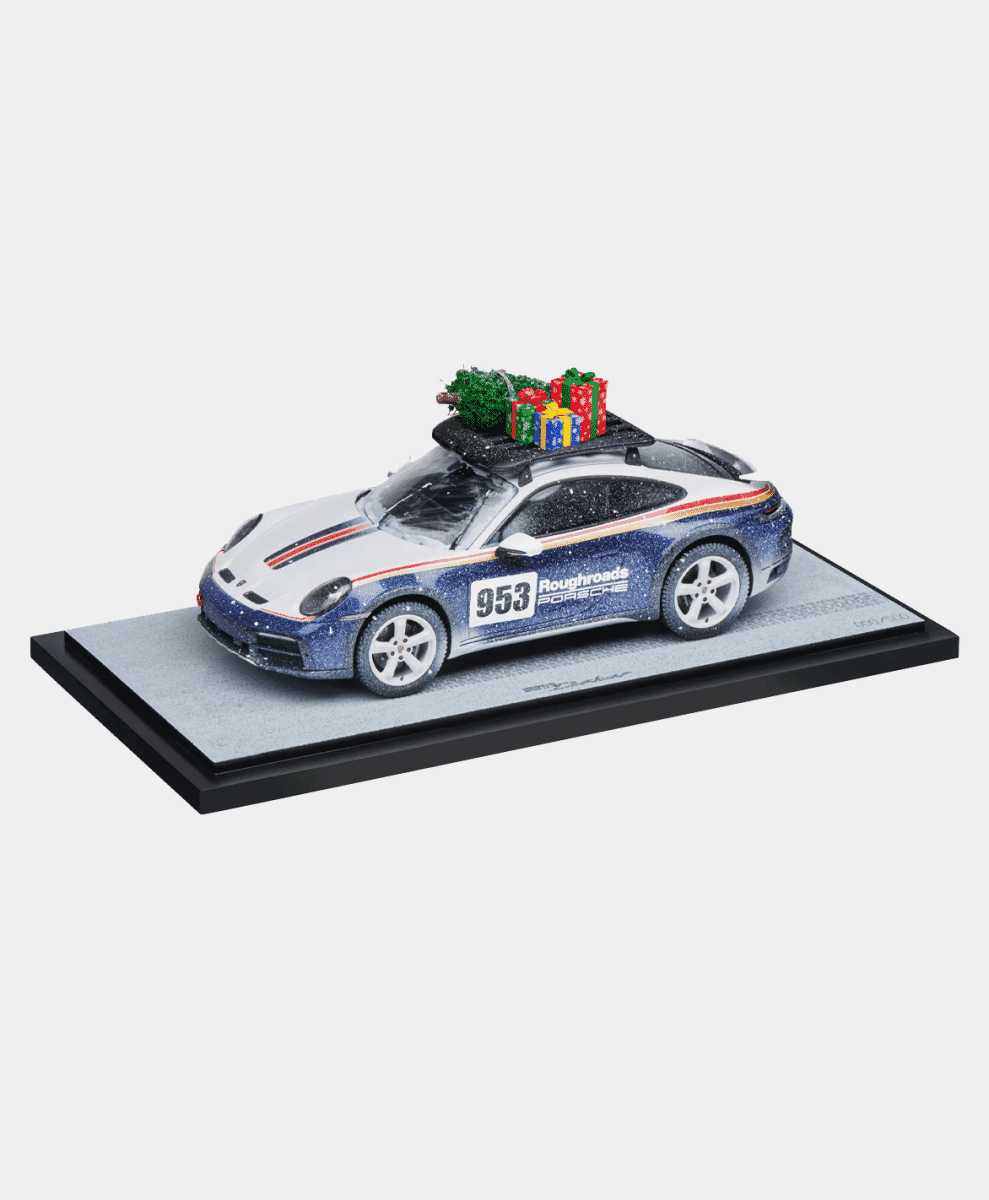 Porsche 911 model car with a Christmas tree on its roof.