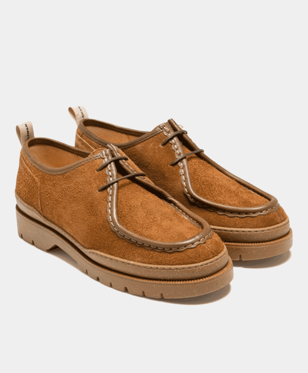 Tan suede derby shoes with thick rubber soles on a clean white background.