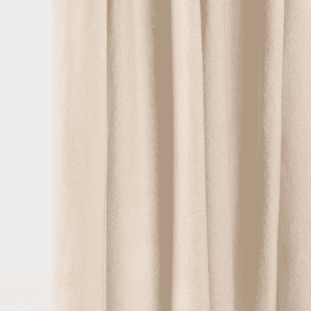 Close-up of soft, cream-colored draped fabric with gentle folds.