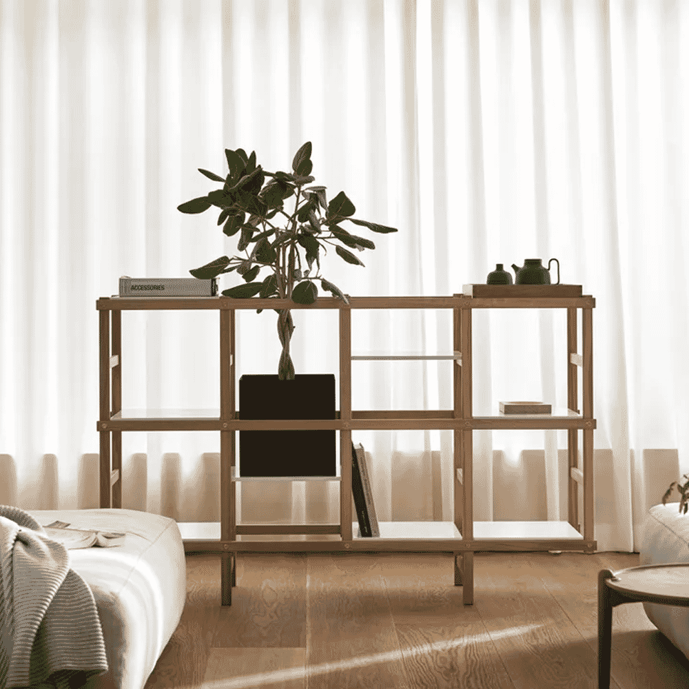 A serene, well-lit minimalist living room with wooden shelving and soft, flowing curtains.