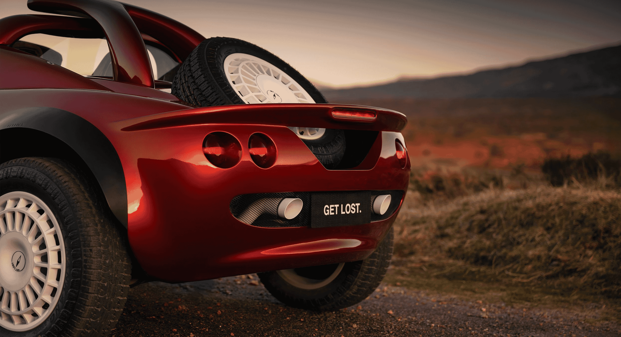 Close-up of a red off-road car with white rally wheels and a spare tire mounted on the rear hatch.