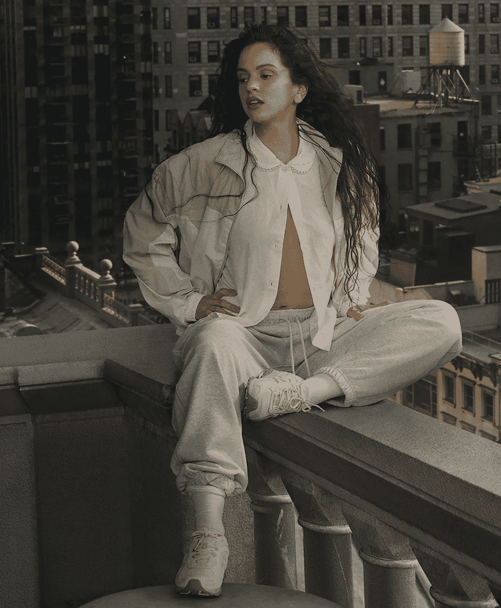 A lifestyle shot of a woman in an urban rooftop setting wearing New Balance 204L sneakers.
